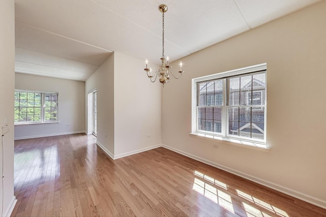 200 N Addison Ave Unit 306, Elmhurst, IL 60126 - spare room featuring a chandelier, wood finished floors, and baseboards