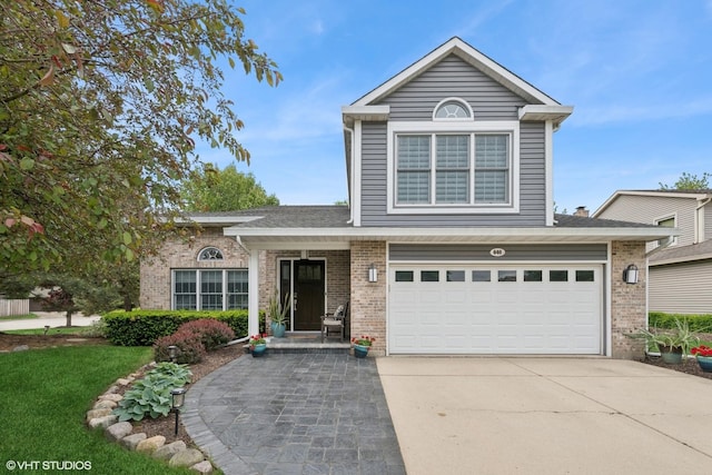 640 Yardley Ln, Hoffman Estates, IL 60169 - traditional-style house featuring brick siding, concrete driveway, and a garage