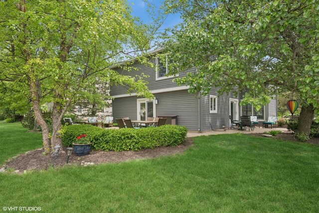 640 Yardley Ln, Hoffman Estates, IL 60169 - back of property with a patio and a lawn