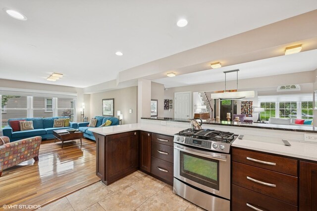 640 Yardley Ln, Hoffman Estates, IL 60169 - kitchen featuring stainless steel gas range, open floor plan, light countertops, dark brown cabinets, and recessed lighting