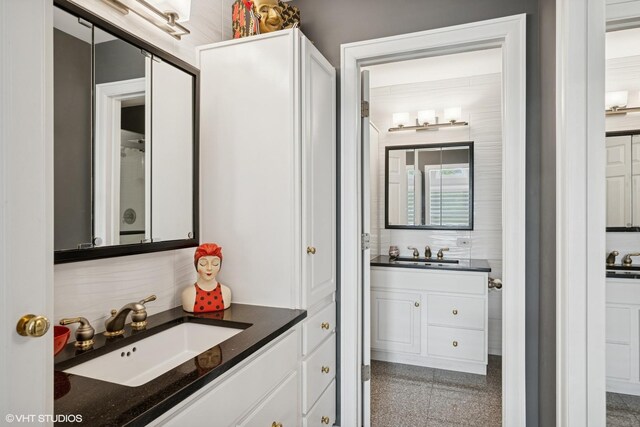 640 Yardley Ln, Hoffman Estates, IL 60169 - bathroom featuring granite tiled floors, vanity, and tasteful backsplash