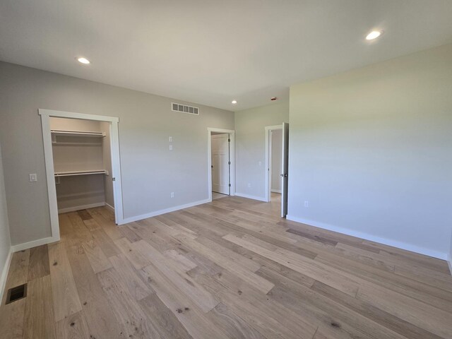 17-95 Lake Carroll Blvd, Lake Carroll, IL 61046 - unfurnished bedroom with light wood finished floors, baseboards, recessed lighting, a spacious closet, and a closet