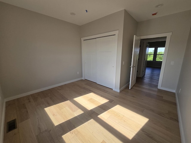 17-95 Lake Carroll Blvd, Lake Carroll, IL 61046 - unfurnished bedroom with wood finished floors, baseboards, and a closet