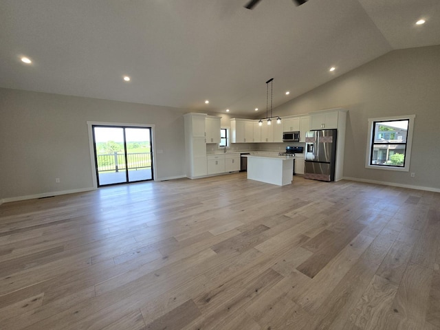 17-95 Lake Carroll Blvd, Lake Carroll, IL 61046 - unfurnished living room featuring recessed lighting, light wood-style flooring, baseboards, a sink, and high vaulted ceiling