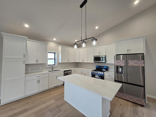 17-95 Lake Carroll Blvd, Lake Carroll, IL 61046 - kitchen featuring stainless steel appliances, a center island, white cabinets, a sink, and light wood-style floors