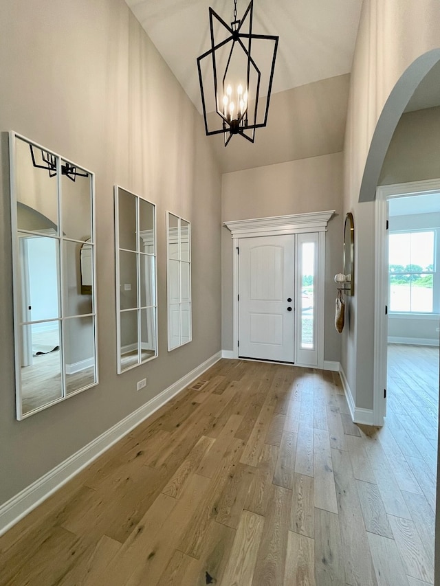 15959 Prairie View Ct Unit T6, New Lenox, IL 60451 - entryway featuring arched walkways, baseboards, wood finished floors, a chandelier, and a towering ceiling