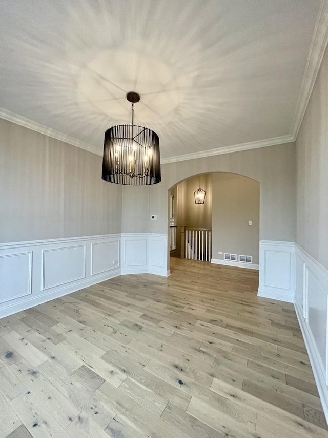 15959 Prairie View Ct Unit T6, New Lenox, IL 60451 - unfurnished dining area with arched walkways, a decorative wall, light wood-style floors, crown molding, and a chandelier