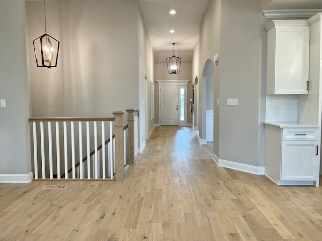 15959 Prairie View Ct Unit T6, New Lenox, IL 60451 - corridor featuring a chandelier, light wood-style floors, arched walkways, and recessed lighting