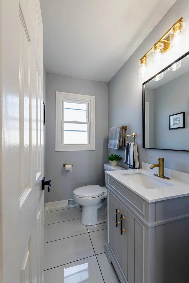22W046 Mccormick Ave, Glen Ellyn, IL 60137 - half bath featuring toilet, vanity, tile patterned flooring, and baseboards