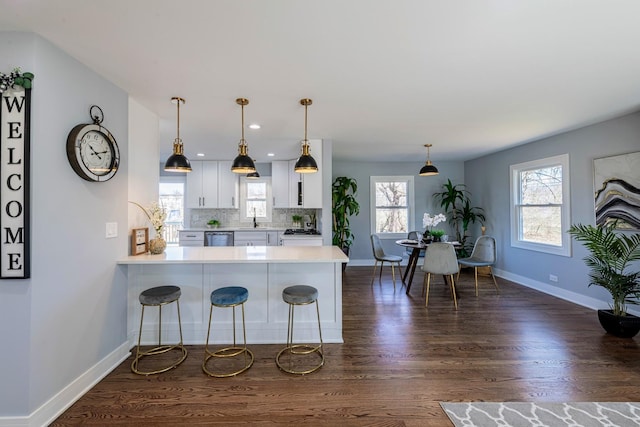22W046 Mccormick Ave, Glen Ellyn, IL 60137 - kitchen featuring baseboards, light countertops, white cabinetry, dark wood-style flooring, and recessed lighting