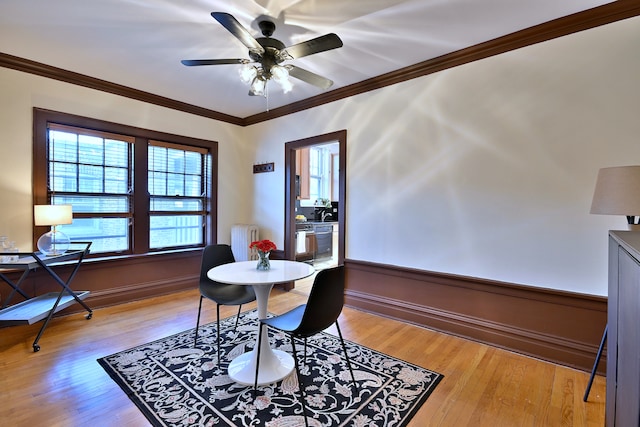 226 N Oak Park Ave Unit 3N, Oak Park, IL 60302 - dining area featuring radiator, crown molding, light wood finished floors, ceiling fan, and baseboards