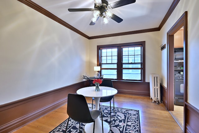 226 N Oak Park Ave Unit 3N, Oak Park, IL 60302 - dining room featuring radiator heating unit, light wood-style floors, ceiling fan, and ornamental molding