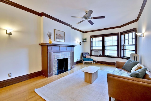 226 N Oak Park Ave Unit 3N, Oak Park, IL 60302 - living area featuring wood finished floors, ornamental molding, baseboards, a fireplace, and a ceiling fan