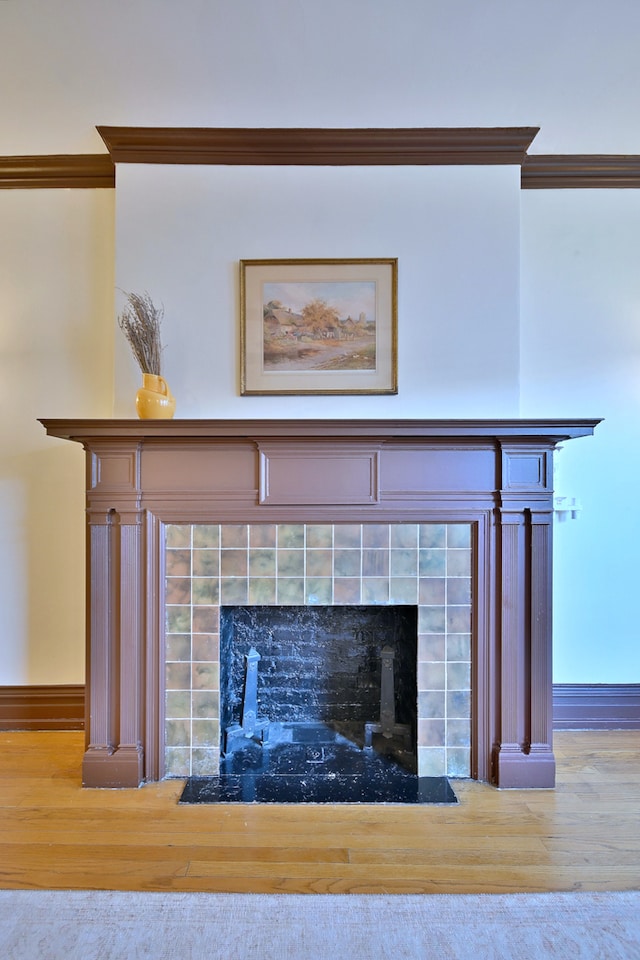 226 N Oak Park Ave Unit 3N, Oak Park, IL 60302 - detailed view of a tiled fireplace, wood finished floors, ornamental molding, and baseboards