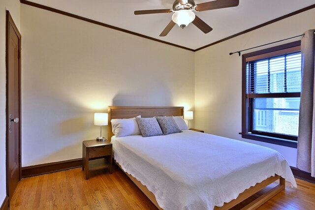 226 N Oak Park Ave Unit 3N, Oak Park, IL 60302 - bedroom featuring crown molding, light wood finished floors, baseboards, and a ceiling fan