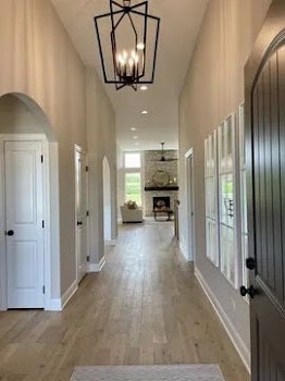 LOTT1015950 Prairie View Ct, New Lenox, IL 60451 - entrance foyer with arched walkways, baseboards, wood finished floors, healthy amount of natural light, and a high ceiling