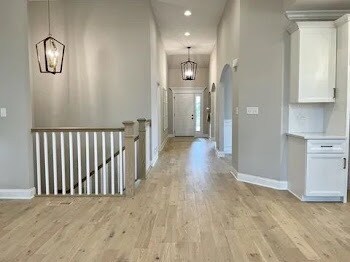 LOTT1015950 Prairie View Ct, New Lenox, IL 60451 - bedroom with vaulted ceiling, light wood-style flooring, a ceiling fan, and baseboards