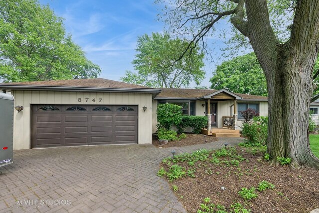 8747 Merrimac Ave, Oak Lawn, IL 60453 - ranch-style house featuring a garage and decorative driveway