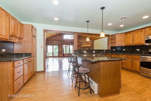 8747 Merrimac Ave, Oak Lawn, IL 60453 - kitchen with appliances with stainless steel finishes, light wood-style flooring, a kitchen breakfast bar, open shelves, and recessed lighting