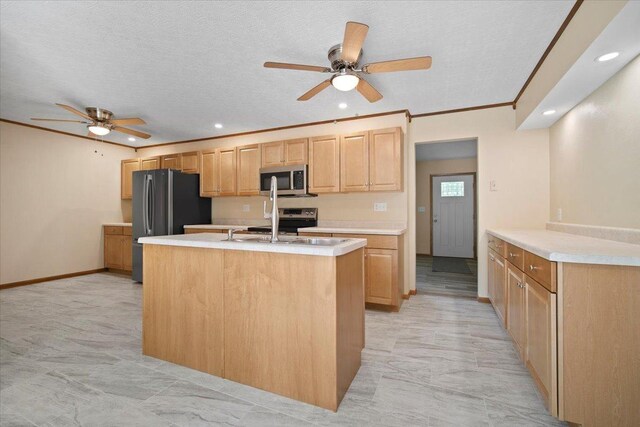 8491 Surrey Cir, Bloomington, IL 61705 - kitchen featuring ceiling fan, appliances with stainless steel finishes, light countertops, light brown cabinetry, and a kitchen island with sink