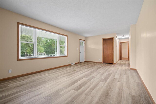 8491 Surrey Cir, Bloomington, IL 61705 - unfurnished living room featuring light wood-style flooring and baseboards