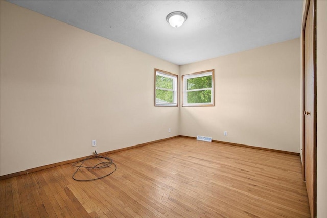 8491 Surrey Cir, Bloomington, IL 61705 - unfurnished room featuring light wood-style flooring and baseboards