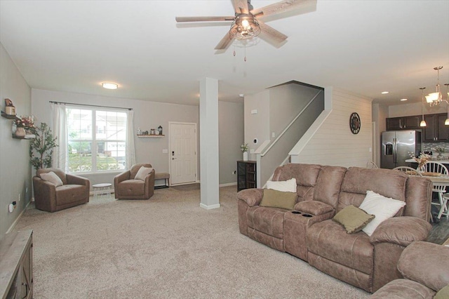 1901 Taos Ln, Volo, IL 60020 - living room featuring light carpet, stairs, a ceiling fan, baseboards, and a chandelier