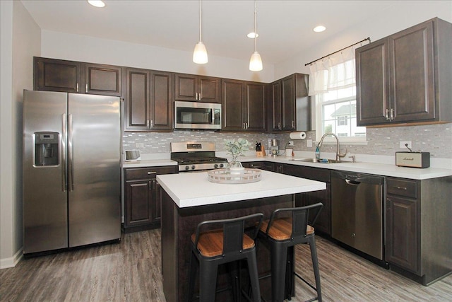 1901 Taos Ln, Volo, IL 60020 - kitchen with appliances with stainless steel finishes, a sink, light wood-type flooring, dark brown cabinetry, and recessed lighting