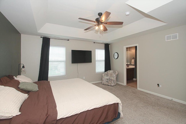 1901 Taos Ln, Volo, IL 60020 - bedroom with a tray ceiling, baseboards, light colored carpet, ensuite bathroom, and a ceiling fan