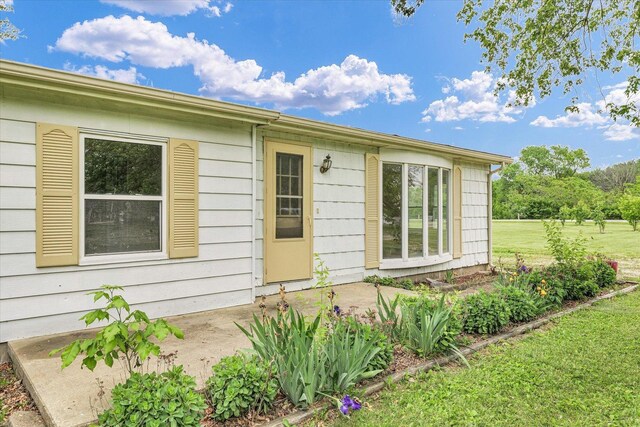 116 Seminole Ln, Loda, IL 60948 - view of exterior entry with a lawn and a patio area