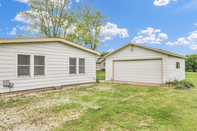 116 Seminole Ln, Loda, IL 60948 - back of house featuring a garage, an outbuilding, and a yard