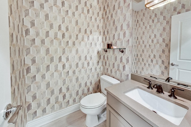 460 W Deming Pl Unit 1E, Chicago, IL 60614 - bathroom with wallpapered walls, toilet, and vanity
