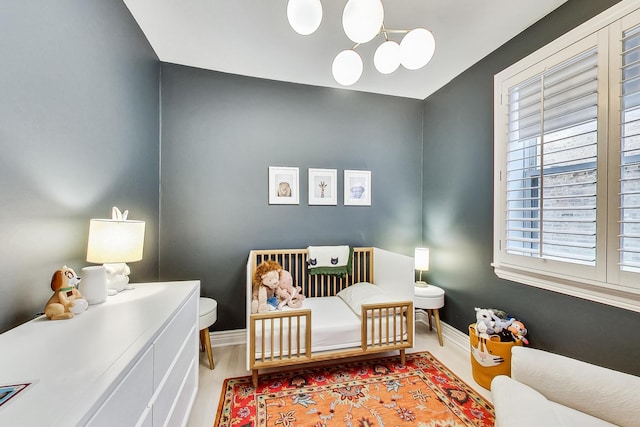460 W Deming Pl Unit 1E, Chicago, IL 60614 - bedroom with a nursery area, baseboards, and wood finished floors