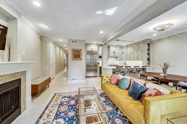 460 W Deming Pl Unit 1E, Chicago, IL 60614 - living room featuring ornamental molding, recessed lighting, light wood-style floors, a fireplace, and baseboards