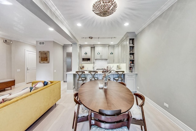 460 W Deming Pl Unit 1E, Chicago, IL 60614 - dining space with baseboards, crown molding, recessed lighting, track lighting, and light wood finished floors