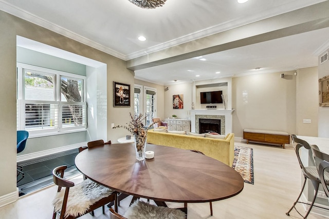 460 W Deming Pl Unit 1E, Chicago, IL 60614 - dining area with light wood-style flooring, crown molding, a fireplace, recessed lighting, and baseboards