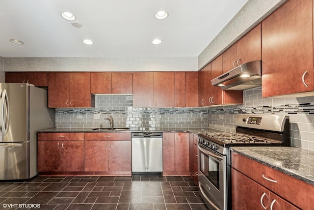 867 Downing Sq, Lincolnshire, IL 60069 - kitchen with appliances with stainless steel finishes, under cabinet range hood, a sink, tasteful backsplash, and dark stone counters