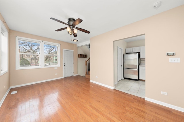 7546 W 61st St, Summit, IL 60501 - empty room featuring ceiling fan, light wood finished floors, stairway, baseboards, and a smoke detector