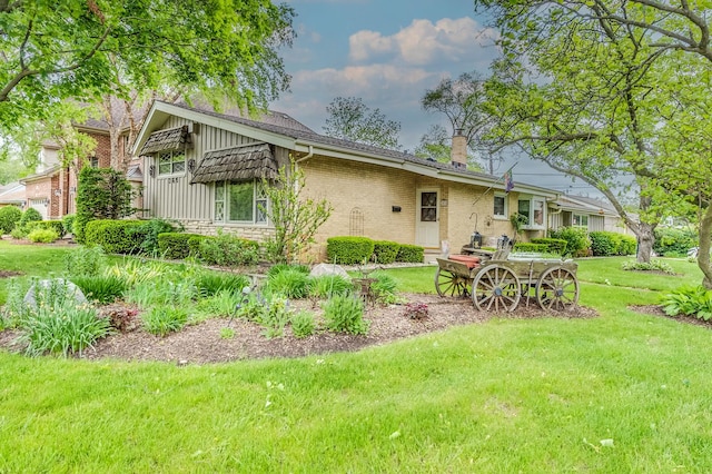 365 S Elm St, Itasca, IL 60143 - rear view of property featuring a yard, a chimney, and brick siding
