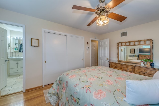 365 S Elm St, Itasca, IL 60143 - bedroom with light wood-type flooring, a closet, connected bathroom, a ceiling fan, and a sink