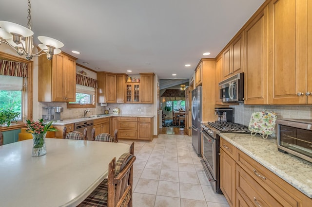 365 S Elm St, Itasca, IL 60143 - kitchen with stainless steel appliances, a chandelier, a sink, backsplash, and light tile patterned flooring