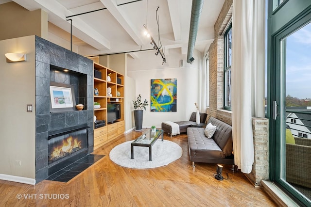 2222 W Diversey Ave Unit 407, Chicago, IL 60647 - living area with wood finished floors, a fireplace, beam ceiling, and baseboards
