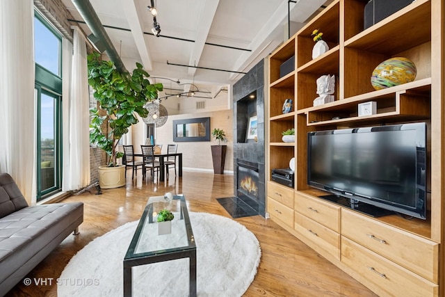 2222 W Diversey Ave Unit 407, Chicago, IL 60647 - living room with track lighting, light wood-style floors, and a fireplace