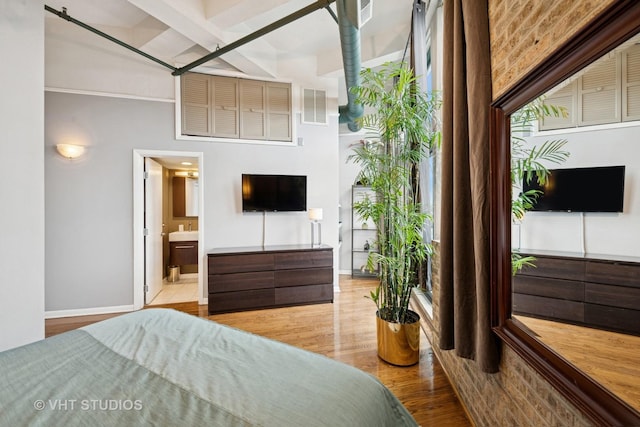 2222 W Diversey Ave Unit 407, Chicago, IL 60647 - bedroom featuring wood finished floors and ensuite bathroom