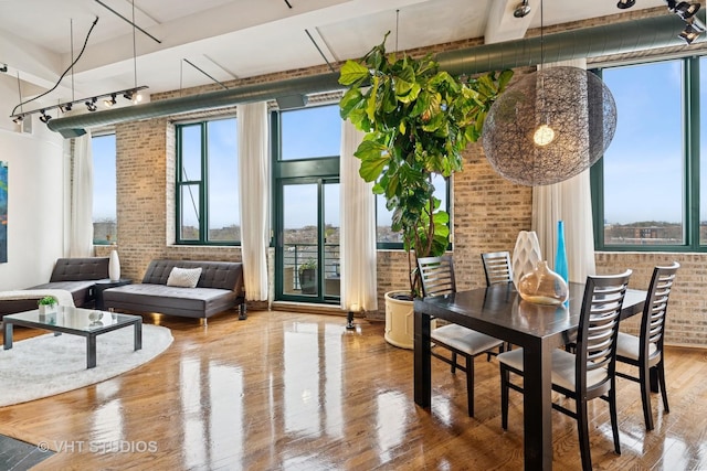 2222 W Diversey Ave Unit 407, Chicago, IL 60647 - dining room featuring brick wall and wood finished floors