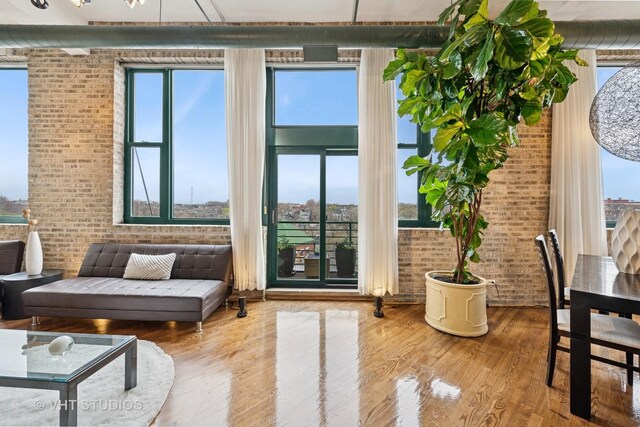 2222 W Diversey Ave Unit 407, Chicago, IL 60647 - living area with brick wall, wood finished floors, and plenty of natural light
