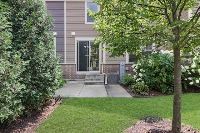 415 Highcroft Way, Lincolnshire, IL 60069 - rear view of house with brick siding, a yard, central air condition unit, and a patio