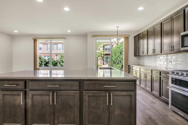 415 Highcroft Way, Lincolnshire, IL 60069 - kitchen with appliances with stainless steel finishes, a sink, recessed lighting, a chandelier, and dark brown cabinets