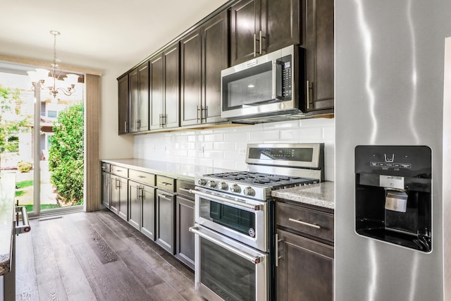 415 Highcroft Way, Lincolnshire, IL 60069 - kitchen with stainless steel appliances, backsplash, dark wood-type flooring, dark brown cabinetry, and a chandelier