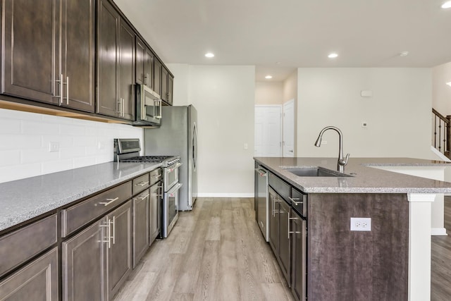 415 Highcroft Way, Lincolnshire, IL 60069 - kitchen featuring a sink, stainless steel appliances, an island with sink, light wood-style floors, and dark brown cabinetry